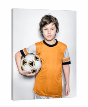 Soccer Player Kid in Orange Uniform With Ball