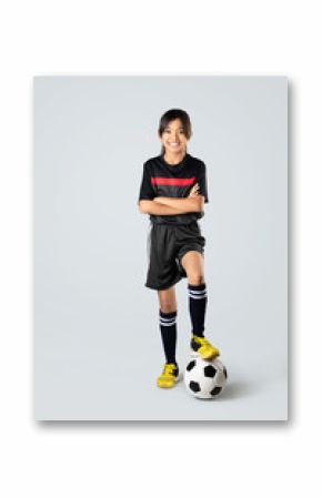 Young asian girl playing soccer, Isolated on grey background