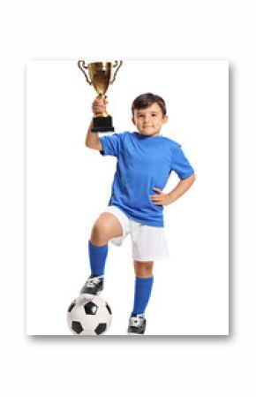 Small boy in blue jersey with football and gold trophy