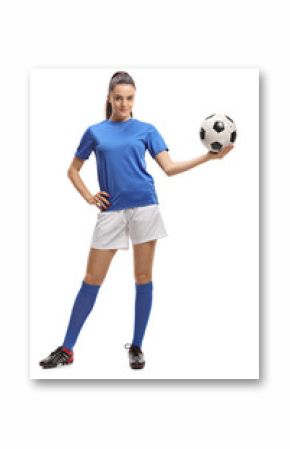 Female soccer player holding a football