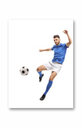 Male soccer player kicking a football in mid-air