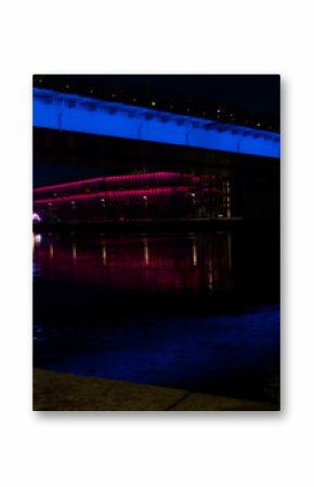 Szczecin city at night.  A view of the Odra river and a amusement park. Neon signs, Poland, Summer 2022