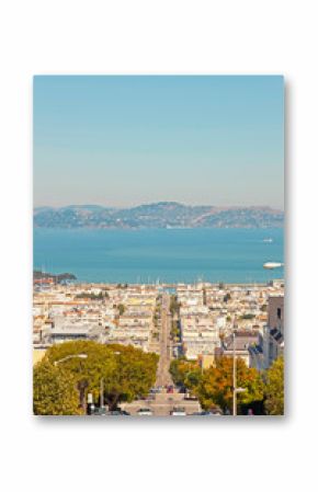 Streets and houses of San Francisco. Blue sky. Ocean and mountai