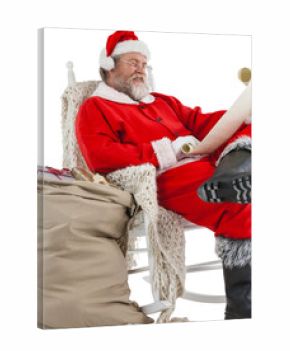 Santa Claus smiling and reading Christmas wish list