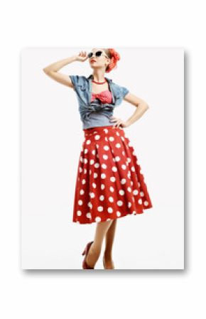 Pin-up young woman in vintage style trying on a sunglasses