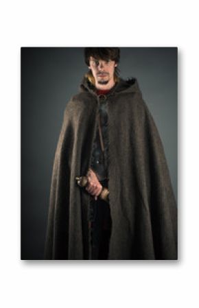 wandering man in woolen cape with a sword