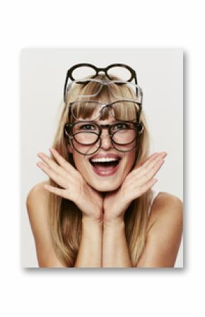 Young blond student posing in many spectacles