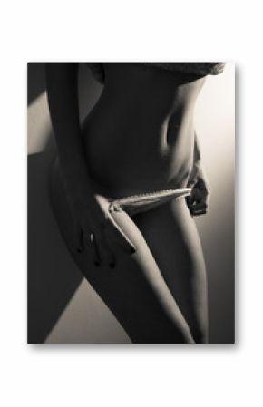 closeup black and white photography on seductive hot fitness flat tummy of young female in white lingerie