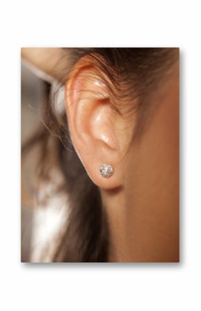 Closeup female ear with a small luxurious earring