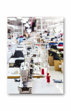 Interior of garment factory shop. Closes making atelier with several sewing machines. Tailoring industry, fashion designer workshop, industry concept