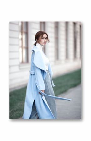 young beautiful stylish woman walking in street in blue coat, autumn fashion trend, smiling, happy.