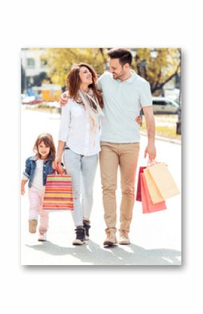 Family walking along the street  with shopping bags