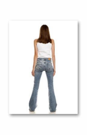 Back view of young pretty woman posing in bell bottom jeans on white background