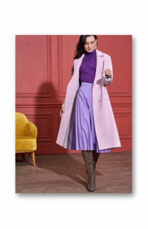 Model posing in studio in trendy clothes