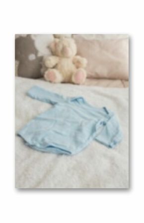 High angle view of clothing by stuffed toy on bed