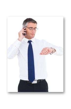 Businessman on the phone looking at his wrist watch