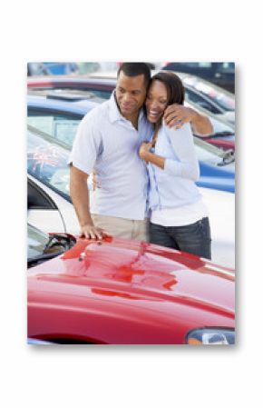Young couple looking at new cars