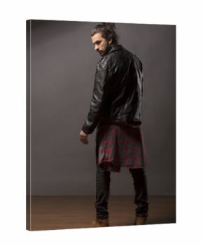 young man with beard and bun in black leather jacket