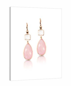 Pink rose quartz and crystal pear shaped drop earrings isolated on white with a reflection