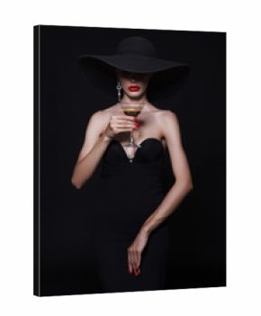 Luxury woman in a large black hat and bright lips with a glass of Martini.