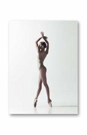 Young graceful female ballet dancer or classic ballerina dancing isolated on white studio. Caucasian model on pointe shoes