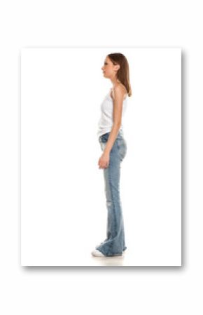 Side view of young pretty woman posing in bell bottom jeans on white background