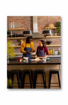 Happy diverse couple baking christmas cookies preparing dough in kitchen, copy space