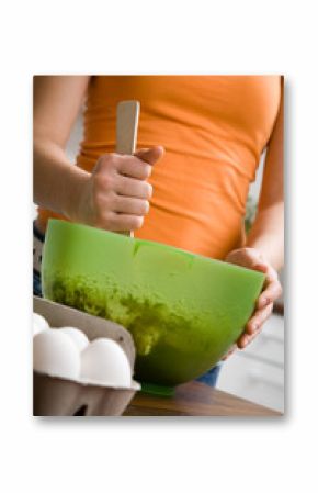 Teenage girl baking chocolate cake