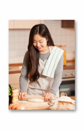 Asian woman is baking bread in her home kitchen