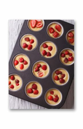 cooking delicious strawberry muffins in baking dish closeup top view  