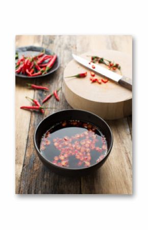 Thai fish Sauce in a cup on wood background