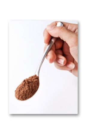 Hand Holding Spoon of Cocoa Powder