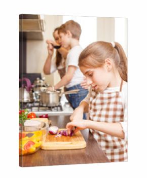 Teenage girl cooking together with her family