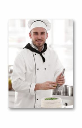 Male chef decorating cake with lime zest