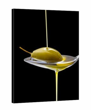Green olive in full oil spoon on black isolated
