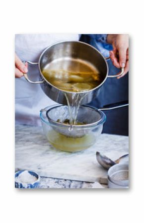 Person making chicken broth stock soup in caserole. Slow cooking food