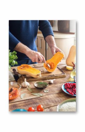 Man cooking healthy food of squash on wooden table