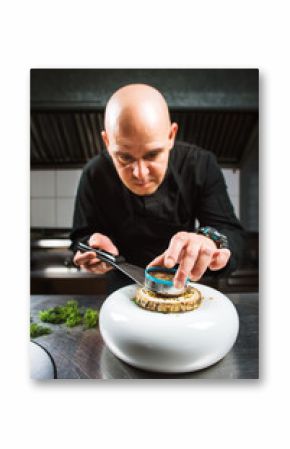 Chef is concentrated on preparing modern molecular dish