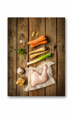 Chicken stock (bouillon, soup) ingredients on wood