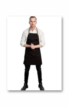 Blonde attractive chef wearing a white shirt and black apron standing with his hands clasped against a white background looking at camera.