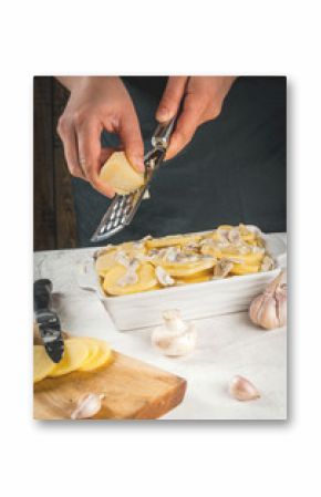 Person is cooking of a traditional French dish - potato gratin: potatoes, milk, cream, eggs, cheese, mushrooms, spices. Casserole. Vegetarian food. Female hands. 