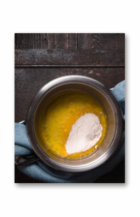 Broth with flour for veloute sauce on the wooden table vertical
