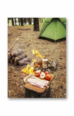 Camping in the forest. Preparation of breakfast at the stake.