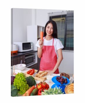 woman holding a carrot in kitchen room
