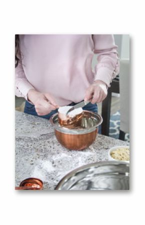 woman cooks and bakes in kitchen with copper bowls 