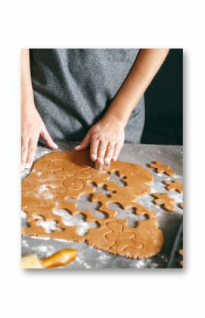 Christmas food. Woman cooking gingerbread man cookies Xmas dessert