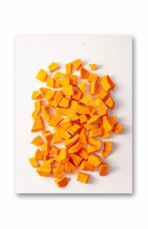 Pieces of pumpkin on a white stone textured background