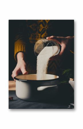 Female hands cooking orange jam for Christmas gifts