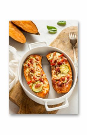 Baked sweet potato with bacon, sour cream, zucchini, red pepper and cheddar cheese.