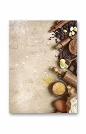 Ingredients for festive baking : flour, brown sugar, eggs, chocolate slices and drops, cocoa, butter and cinnamon.Top view with copy space.